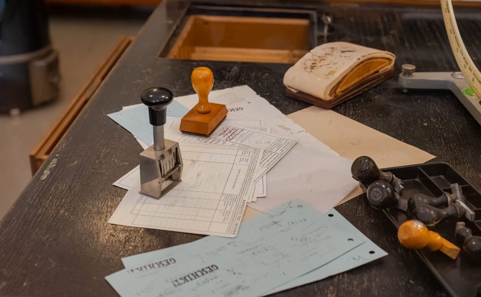 Rubber stamps and a numbering machine resting on official paperwork, representing the document approval process in Pakistan customs clearance