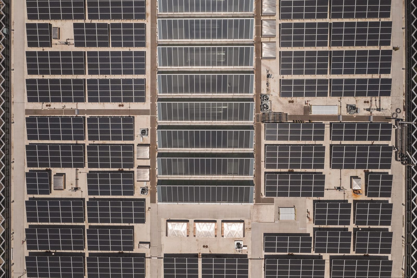 Aerial view of a large solar panel array installed across an industrial rooftop, representing solar panels imported into Pakistan