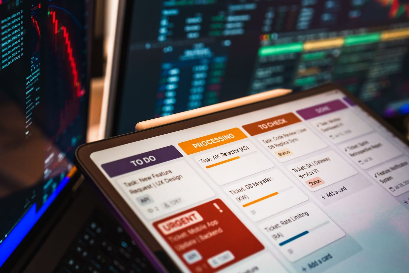 Digital task board displayed on a tablet in front of data-filled monitors, representing the WeBOC and Pakistan Single Window electronic clearance systems